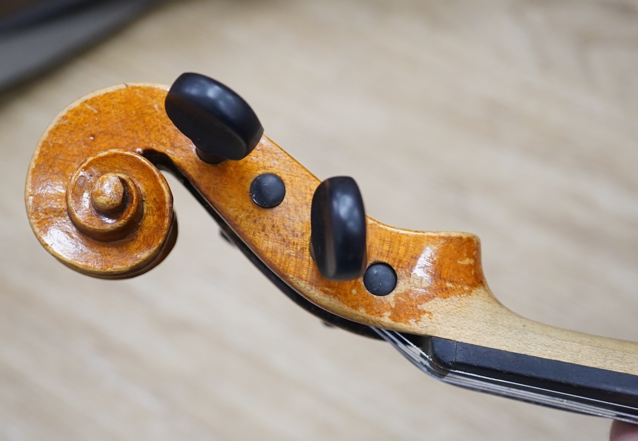 Two cased three quarter size violins, one labelled the London violin Co Ltd, length of back 33.5cm. Condition - both scratched